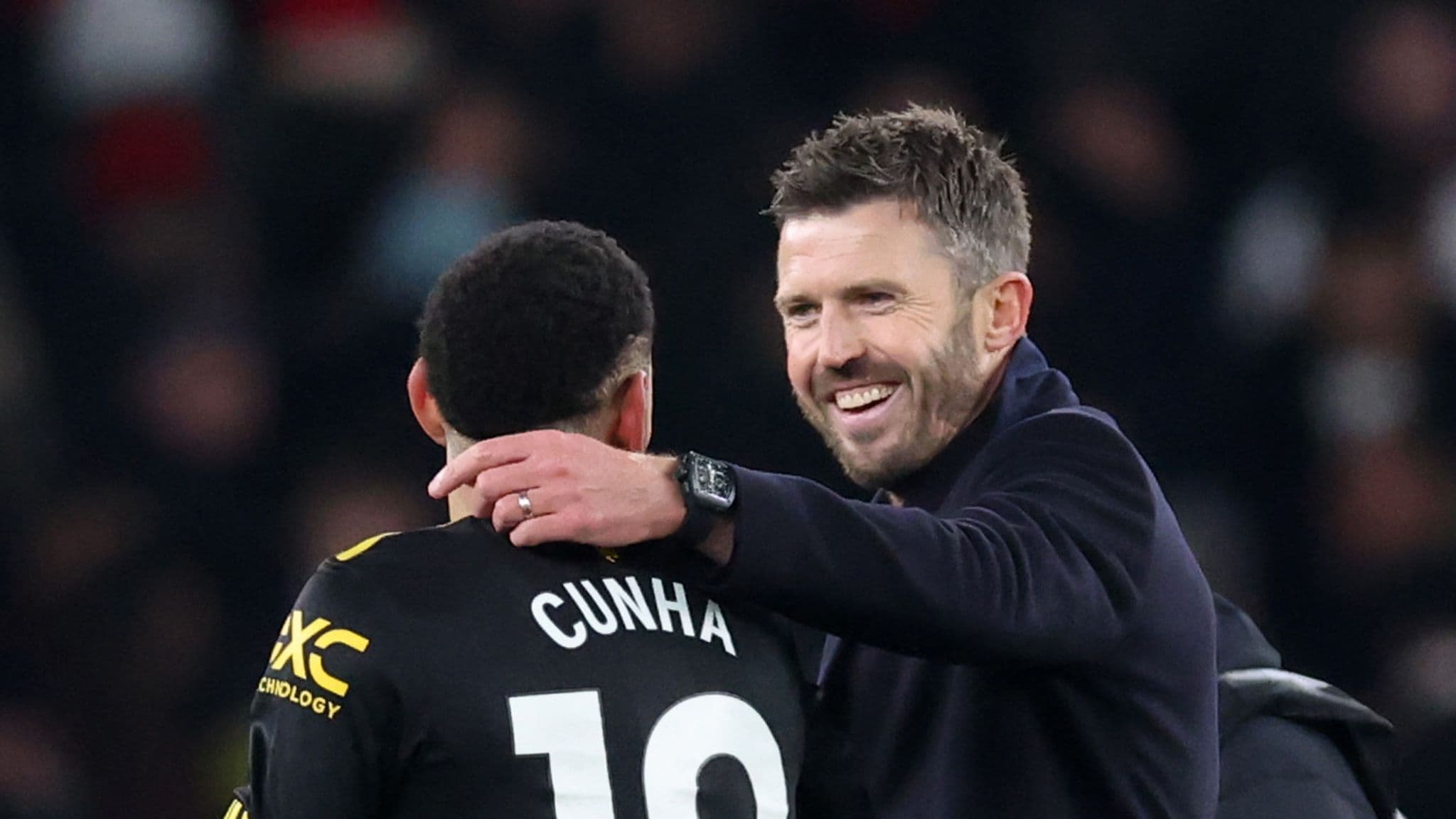 Michael Carrick embraces Matheus Cunha after Man United's win over Arsenal.